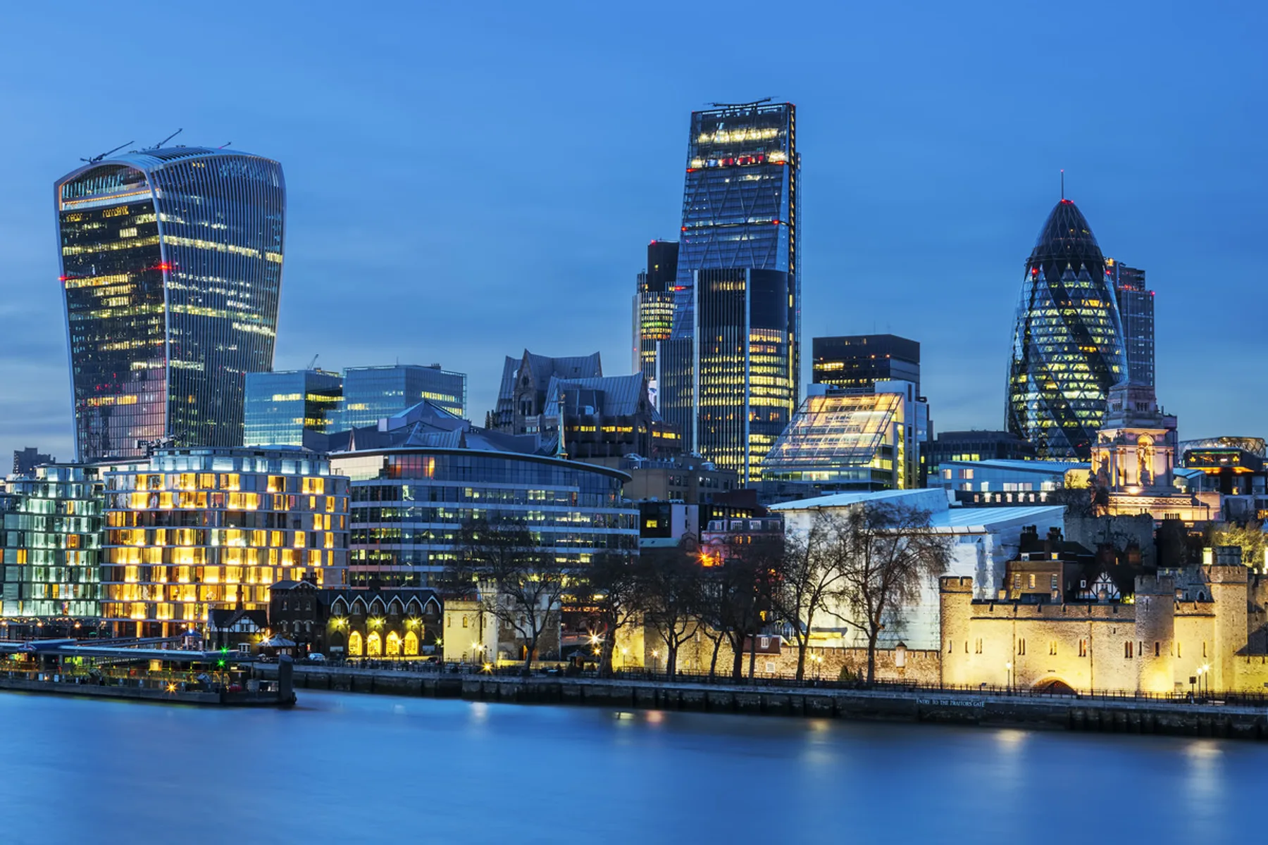 The City of London skyline at dusk, seen across the Thames